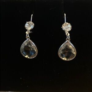 Handcrafted silver tone earrings with a clear stone.
